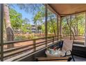 Relaxing screened porch with comfortable seating and a scenic view of the surrounding greenery and building exterior at 415 Ocean Creek Dr. # 2161, Myrtle Beach, SC 29572