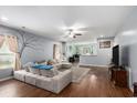 Spacious living room featuring wood floors, a comfortable sectional, and an open layout at 436 Cotton Grass Dr., Loris, SC 29569