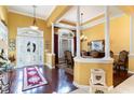 Open concept home featuring a grand foyer with hardwood floors and elegant dining area at 4608 Grovecrest Circle, North Myrtle Beach, SC 29582