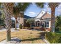 Charming brick home featuring a well-manicured lawn and palm trees in a desirable neighborhood at 4608 Grovecrest Circle, North Myrtle Beach, SC 29582