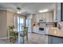 Bright kitchen with white appliances, a dining area, and an ocean view from the sliding glass door at 5905 S Kings Hwy. # 1717, Myrtle Beach, SC 29575