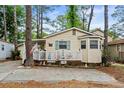 Charming single-story home featuring a cozy porch and well-maintained landscaping at 6001-1501 S Kings Hwy., Myrtle Beach, SC 29575
