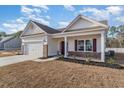 Inviting single-story home with brick accents, a two-car garage, covered porch, and manicured landscaping at 610 Lightwood Dr., Conway, SC 29526