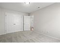 A neutral bedroom with carpet, closet, and door leading to other rooms at 614 Lightwood Dr., Conway, SC 29526