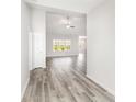 Inviting hallway with wood-look floors leading to a bright living area with large windows at 618 Lightwood Dr., Conway, SC 29526