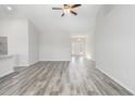 Open-concept living room with vaulted ceiling, gray wood-look floors, and lots of natural light at 618 Lightwood Dr., Conway, SC 29526