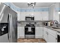 Well-equipped kitchen featuring stainless steel appliances, granite countertops, and starfish accents for a coastal touch at 720 N Waccamaw Dr. # 202, Garden City Beach, SC 29576