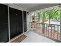 Condo's covered balcony with white railings and wood floors offers an inviting outdoor space at 75-4 Weehawka Way # 4, Pawleys Island, SC 29585