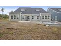 New construction home with a partially-finished patio and expansive backyard at 8803 Reya Rd # 163B, Longs, SC 29568