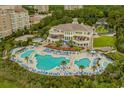 An aerial view showcasing the sprawling pool area surrounded by lounge chairs and lush greenery at 9485 Ronda Ct., Myrtle Beach, SC 29579