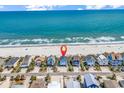 Aerial view of oceanfront homes with access to a beautiful beach at 969 S Waccamaw Dr., Garden City Beach, SC 29576