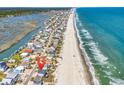 Aerial view of beach homes on stilts with ocean on one side and river on the other at 969 S Waccamaw Dr., Garden City Beach, SC 29576