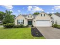 Charming single-story home with well-manicured lawn, landscape beds, and an attached two-car garage at 9831 Winchester Ct., Murrells Inlet, SC 29576