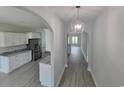 Hallway view into a kitchen with stainless steel appliances and granite countertops at Tbd 7 Duford Rd., Nichols, SC 29581