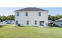 Spacious backyard with a well-maintained lawn and rear exterior of the house at 1031 Snowberry Dr., Longs, SC 29568