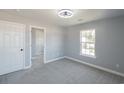 Bright bedroom with a closet featuring gray carpet and neutral paint at 1031 Snowberry Dr., Longs, SC 29568