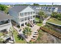 Spacious backyard featuring a waterfront view, a pool, and multiple lounge chairs for relaxation at 107 Waterway Crossing Ct., Little River, SC 29566