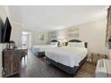 Bright bedroom featuring two queen beds, wood floors, TV, dresser, and balcony access at 1105 S Ocean Blvd. # 724, Myrtle Beach, SC 29577