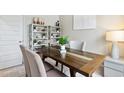 Bright dining area with rustic table and modern shelving unit display at 1221 American Shad Dr. # 41, Conway, SC 29526