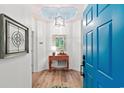 Foyer showcasing hardwood floors, stylish table, and an ornate glass decoration, viewed through a blue front door at 1221 Tidewater Dr. # 2811, North Myrtle Beach, SC 29582