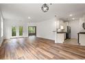 Open-concept living area flows into the kitchen, with hardwood floors, neutral walls, and natural light at 144 Puffin Dr. # 2A, Pawleys Island, SC 29585