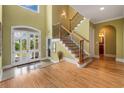 Grand foyer with beautiful hardwood floors, a staircase, and a bright entry door with sidelights at 166 Cayman Loop, Pawleys Island, SC 29585