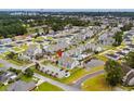 Aerial view of a condo complex with a pool and a pond, showcasing community amenities and well-maintained landscaping at 1891 Colony Dr. # 15 J, Surfside Beach, SC 29575