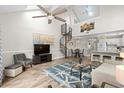 Bright living room featuring high ceilings, a spiral staircase, and stylish decor, creating a modern and inviting space at 1891 Colony Dr. # 15 J, Surfside Beach, SC 29575