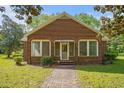 Classic brick home with a brick walkway and ample natural light from multiple windows at 1895 Bucksville Dr., Conway, SC 29527