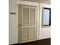 Image shows the apartment door of unit B-123 with a beige, louvered door and dark framed window at 191 Maison Dr. # B-123, Myrtle Beach, SC 29572