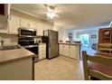 Open concept kitchen with stainless steel appliances seamlessly connects to the living area at 191 Maison Dr. # B-123, Myrtle Beach, SC 29572