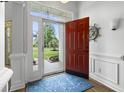 Bright entryway with a red front door, blue rug, and decorative nautical accents at 2191 Deerfield Ave., Surfside Beach, SC 29575
