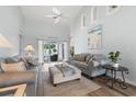 Airy living room features vaulted ceilings, coastal decor, and sliding glass doors to the outdoor space at 2191 Deerfield Ave., Surfside Beach, SC 29575
