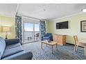 Cozy living room featuring a balcony, comfortable seating, and a TV for relaxing evenings at 2201 South Ocean Blvd. # 1808, Myrtle Beach, SC 29577