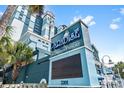 Eye-level exterior shot of building signage reading 'Paradise Oceanfront Resort' with its address at 2201 South Ocean Blvd. # 1808, Myrtle Beach, SC 29577