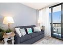 Cozy living room with sofa and a sliding door to the balcony with a view at 2311 South Ocean Blvd. # 559, Myrtle Beach, SC 29577