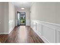 Entryway with wainscoting and rich wood flooring provides a welcoming first impression at 2317 Myerlee Dr., Myrtle Beach, SC 29588