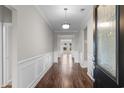 Inviting entryway with elegant wainscoting, wood floors and decorative light fixture at 2317 Myerlee Dr., Myrtle Beach, SC 29588