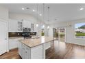 Bright, open kitchen with island, granite countertops, stainless steel appliances, and views of the pond at 2317 Myerlee Dr., Myrtle Beach, SC 29588