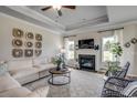 Bright living room featuring a fireplace, large windows, and modern decor at 240 Wagner Cir., Conway, SC 29526