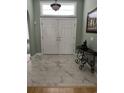 Elegant foyer featuring marble tile flooring, white double doors, and transom window at 3012 Winding River Rd., North Myrtle Beach, SC 29582