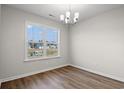 A chandelier hangs in the dining room with a large window view at 339 Barn Owl Way, Conway, SC 29527