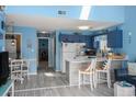 Inviting living area with blue walls, open floor plan, dining area, and a sunlit breakfast bar at 3700 Golf Colony Lane # 6J, Little River, SC 29566