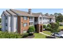 A view of the exterior side of an apartment building, showing its architectural details and landscaping at 3795 Hitchcock Way # 618, Myrtle Beach, SC 29577