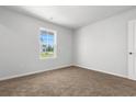 Bright bedroom features cozy carpeting, neutral walls, a window providing natural light, and a door at 40 Cape Point Dr., Conway, SC 29527