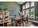 Elegant dining room with decorative trim, hardwood floors, a chandelier, and large windows at 4260 Long Avenue Ext., Conway, SC 29526