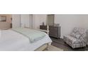 Comfortable bedroom with a relaxing chair, dresser, and light-colored walls and flooring at 4458 East Coast Ln., Shallotte, NC 28470