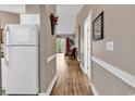 Inviting hallway leads to a living area featuring hardwood floors, neutral tones and a bright, airy ambiance at 4787 Wild Iris Dr. # 303, Myrtle Beach, SC 29577