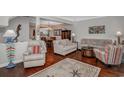 Bright living room with hardwood floors, comfortable seating, and an open view into the adjacent dining area at 601 Hillside Dr. N # 302, North Myrtle Beach, SC 29582