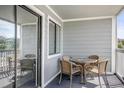 Balcony with outdoor table and chairs and view of neighboring buildings at 612 N Ocean Blvd. # 103, Surfside Beach, SC 29575